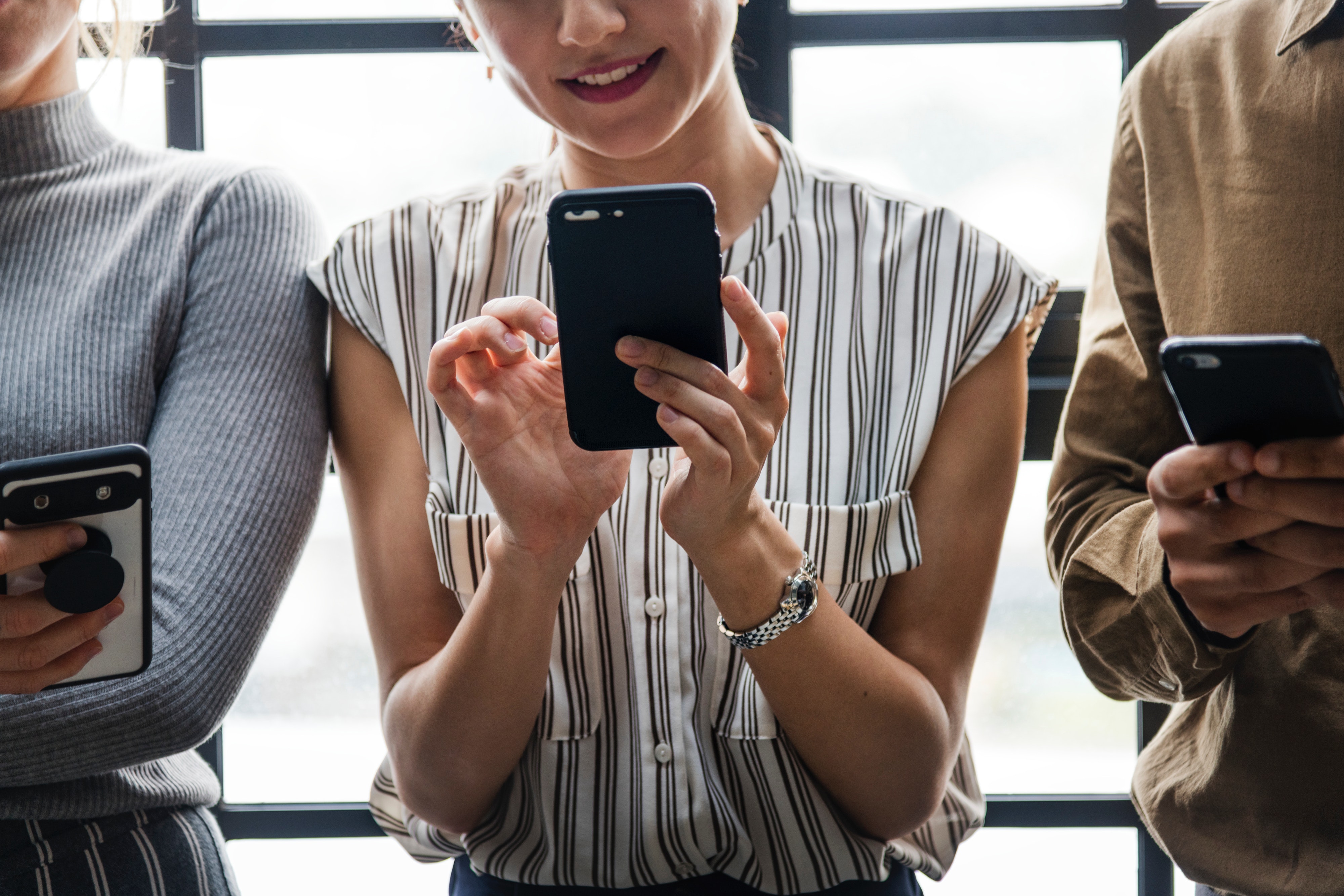 Adults busy on cellphones 